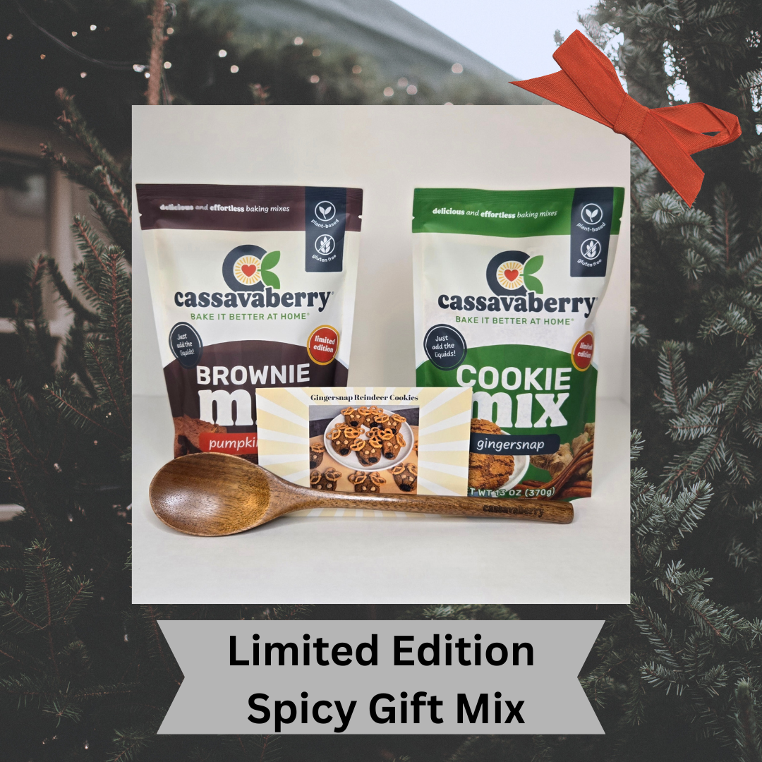 Cassavaberry Pumpkin Spice Brownie Mix and Gingersnap Cookie Mix packages with a Cassavaberry wooden mixing spoon and recipe card to make Gingersnap Reindeer Cookies against a Christmas tree background.