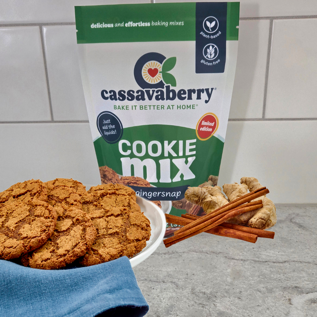 Cassavaberry gingersnap cookie mix with cookies and cinnamon sticks and ginger on a countertop.