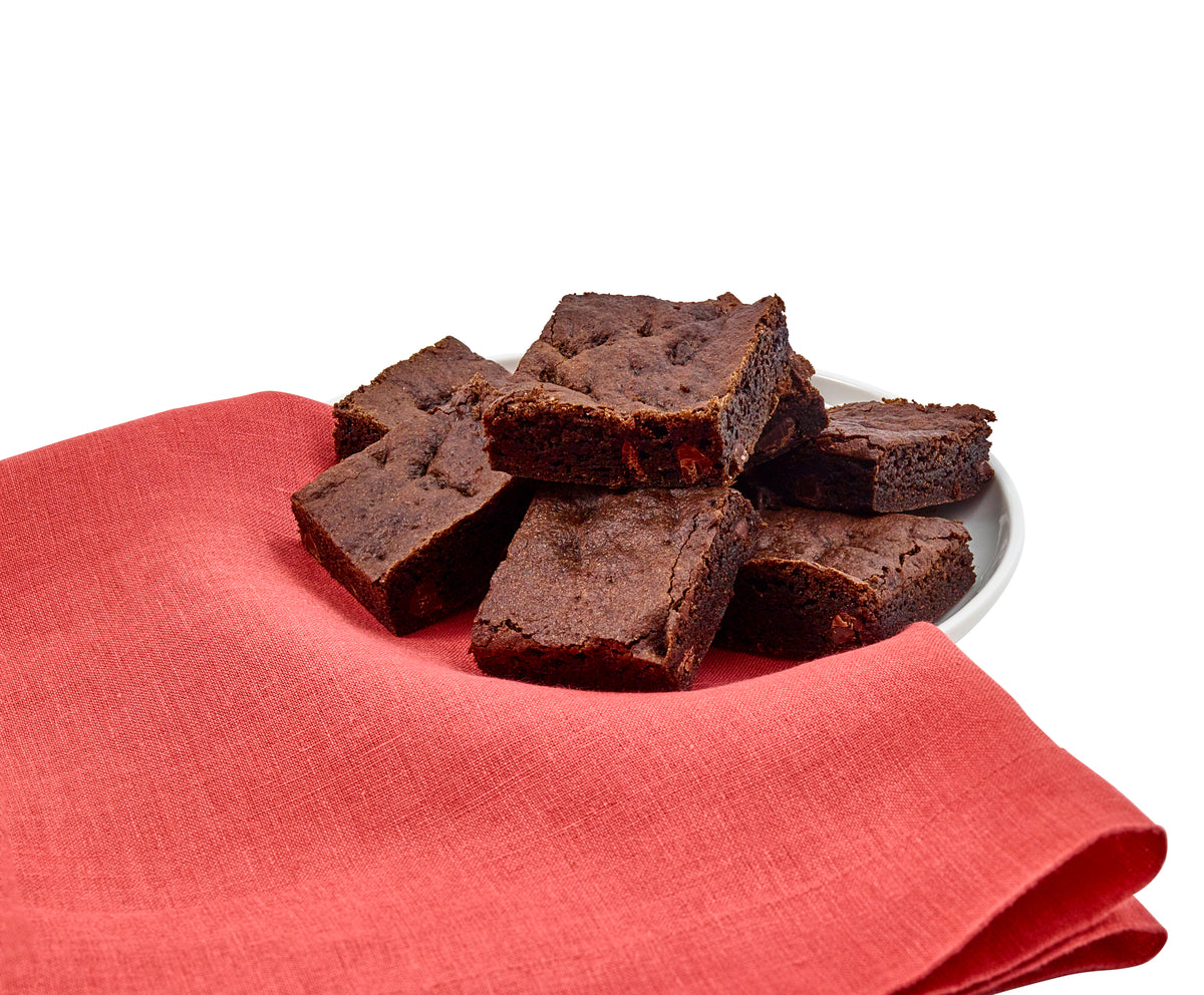 Brownies on a white plate with a red cloth underneath