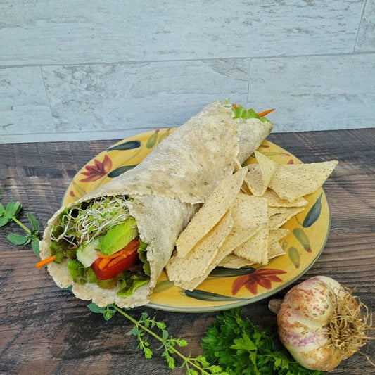Our Garlic & Herb Tortilla veggie wrap stuffed with lettuce, sprouts, tomato, cucumber and avocado.
