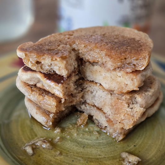 Stack of 4 pancakes stacked on a plate.