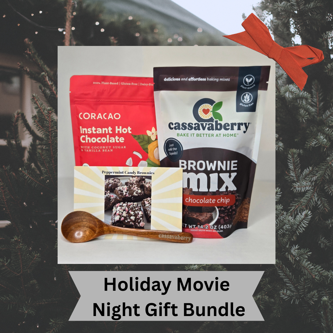 Holiday Movie Night Bundle with Coracao Plant Based Instant Hot Chocolate and Cassavaberry Brownie Mix, with a Cassavaberry mini spoon and a recipe card to make Peppermint Candy Brownies against a Christmas tree background.