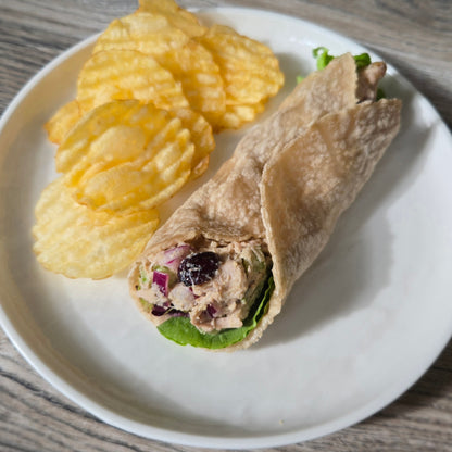 Made from Cassavaberry Tortilla Mix, Jackfruit salad wrap on a plate with potato chips.