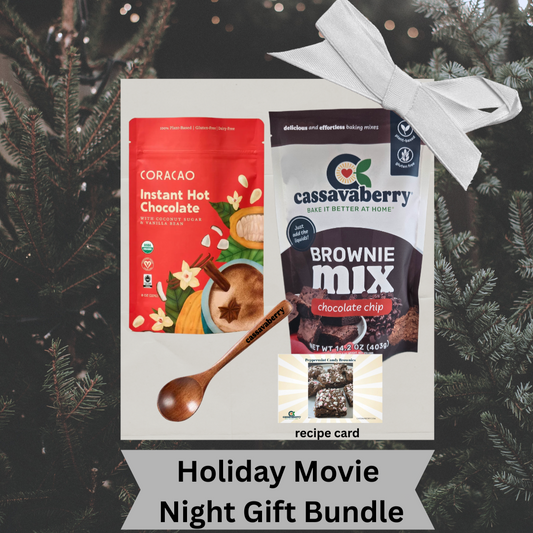 Holiday Movie Night Bundle with Coracao Plant Based Instant Hot Chocolate and Cassavaberry Brownie Mix, with a Cassavaberry mini spoon and a recipe card to make Peppermint Candy Brownies against a Christmas tree background.