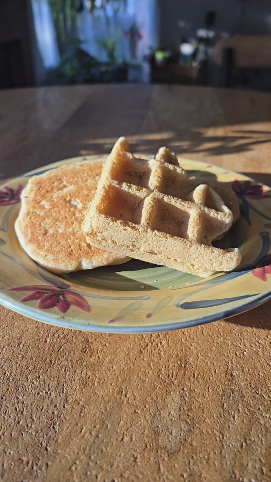 Pouring syrup over a gluten free and vegan pancake and waffle.